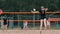 Woman volleyball serve. Woman getting ready to to serve the volleyball while standing on the beach slow motion.