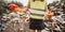 Woman volunteer with bubbles helps clean the field of plastic garbage.