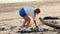 Woman volunteer collect trash from the sea beach in a trash bag