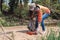 Woman volunteer picks up a plastic bottle on the sandy Bank of the river. Close up. Concept of Earth Day