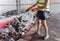 Woman-volunteer sorting trash at modern recycling plant.