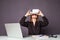 Woman in VR glasses. Confident young woman in virtual reality headset pointing in the air while sitting at her working place in of