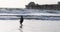 Woman wades plays beach surf sunset oceanside pier California 4K