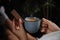 Woman with wafer and coffee on background, closeup. Early breakfast