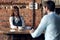 woman waiter brings coffee to a cafe client