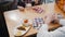 A woman waiter brings food to a couple on the table - indoors