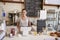 Woman waiting behind the counter at a coffee shop, close up