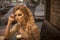 Woman is waiting. Sensual woman with curly blonde hair and makeup in restaurant. Business on go. bar customer in cafe