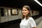 Woman waiting subway car on platform