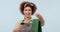 Woman, waitress and coffee with paper bag, food and smile for good service, blue studio background. Portrait, business