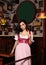 Woman waitress posing in bar with glass of beer