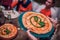 Woman waitress in serving pizza in the Italian restaurant.