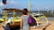 Woman waling on the beach with luxury snakeskin python bag. Tropical island Bali, Indonesia.