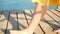 Woman walk barefoot feet on old wooden Pier on a sea