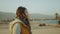 Woman walk on beach and looking Into Horizon. View of sand beach and blue sea from back of female, slow motion, full hd