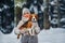 A woman on a walk with her dog in the winter forest. mistress and dog game in the snowy forest