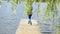 Woman walk wood lake bridge willow tree swan bird meet angry