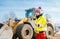 Woman with walkie talky on compost facility dispatching deliveries