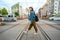 Woman walking across the railroad holding phone