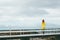 Woman walking alone on bridge Travel Lifestyle emotional concept vacations outdoor yellow raincoat clothing foggy mountains