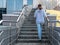 Woman walking alone climb the stairs in a modern neighborhood of a big city