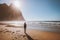 Woman walking alone on Kvalvika beach in Norway enjoying ocean view