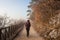 Woman walking alone on rural misty path