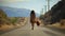 Woman walking along a country road with luggage