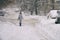 Woman walking along a snowbound Moscow street in February