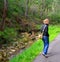 Woman Walking along Stream