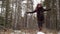 Woman walking along the winter woods in snow