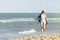 Woman walking away on the idylic beach.