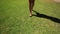 Woman walking barefoot on the grass