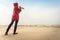 Woman walking on beach with camera