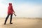 Woman walking on beach with camera