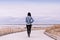 A woman walking on a boardwalk