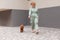 Woman walking in the city with brown Toy Poodle