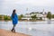 Woman walking in city park relaxing on weekend. Person enjoying lake view in Copenhagen, Denmark. Spring lifestyle