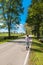 Woman walking country road along horse farms