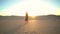 Woman walking on the desert during sunset, relaxing. Calm girl
