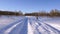 Woman is walking with a dog that runs through white snowdrifts. Slow Motion.