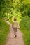 Woman walking down a footpath on a sunny day.