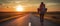 Woman Walking Down Road at Sunset, Tranquil Outdoor Scene of a Woman Enjoying the Evening