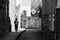 Woman Walking Down a Shaded Medieval Cobbled Street.