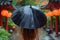 Woman Walking Down Street Holding Umbrella