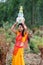 Woman walking with earthen pots