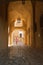 Woman walking through the entrance to the citadel in Calvi, Corsica