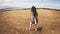 Woman walking in a field close to the sea and cliffs. Asturias, Spain