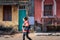 Woman walking in front of colorful houses in Fontainhas, Panaji, Goa, India