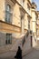 A woman walking in front of the Faculty of Catholic Theology, located on Josipa Stadlera street